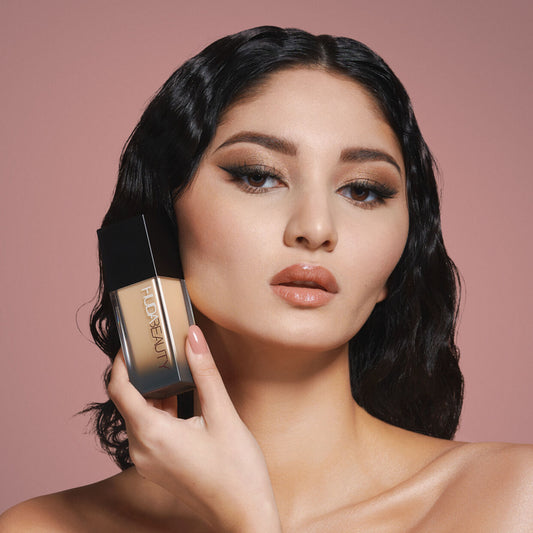 Huda Beauty FauxFilter Luminous Matte Foundation in shade Panna Cotta, showcasing a liquid foundation bottle with a pump applicator.