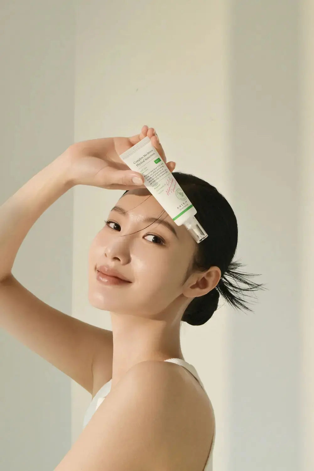 AXIS-Y Complete No-Stress Physical Sunscreen V.3 in a 50ml tube, showing the sunscreen's packaging and applicator.
