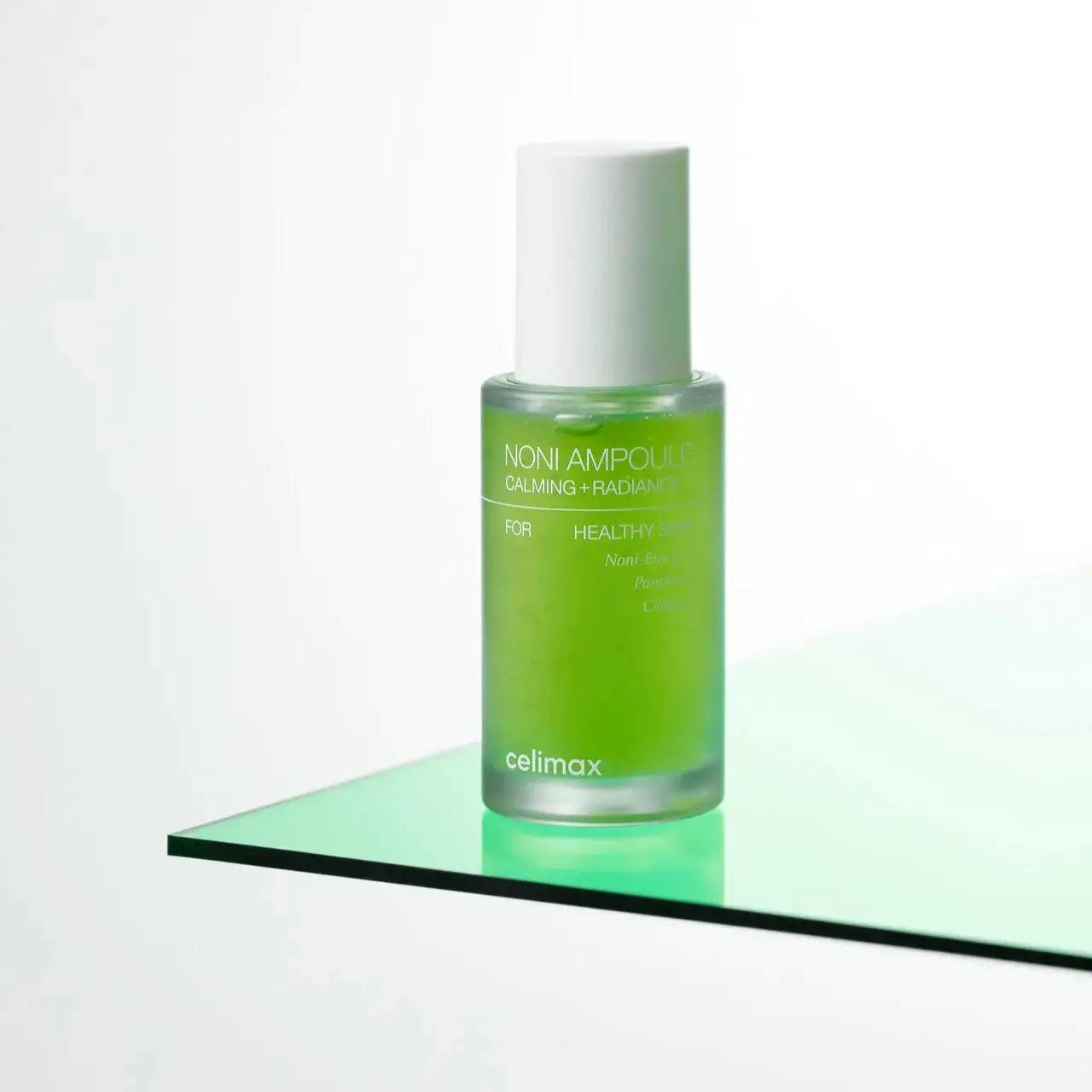 CELIMAX The Real Noni Energy Ampoule 30 ml, clear glass bottle with dropper, showcasing the skin-boosting ampoule for radiant skin.