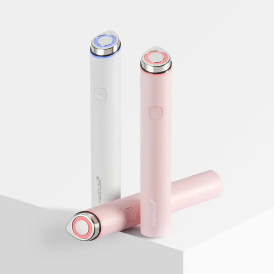 Medicube AGE R Booster Pro Mini in pink, compact skincare bottle with pump for anti-aging treatment.