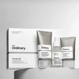 Set of skincare products from THE ORDINARY's The Daily Set, including bottles and tubes arranged on a neutral background.