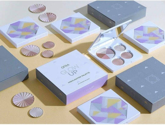 OFRA Glow Up Highlighter Palette with multiple shimmering shades in a compact makeup palette.