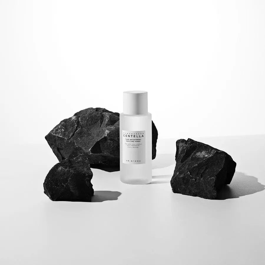 SKIN1004 Madagascar Centella Brightening Toner bottle, natural skin tone, with a minimalist label and clear liquid inside.