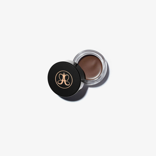 Anastasia Beverly Hills DIPBROW® Pomade in Auburn, brow makeup product with a small jar and brush for defining eyebrows.