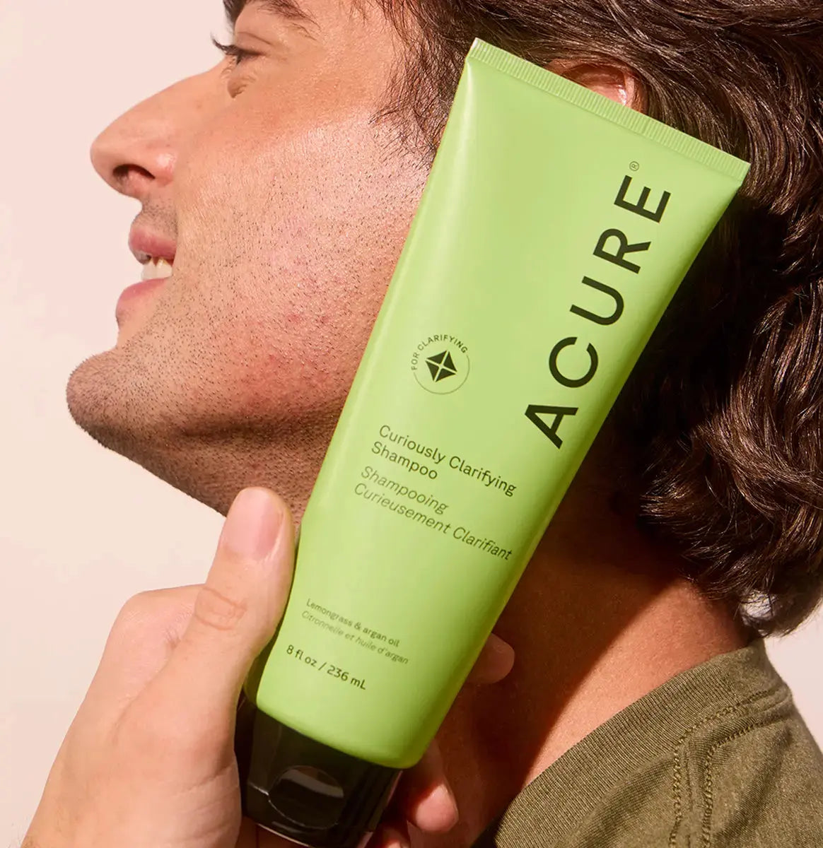 ACURE Curiously Clarifying Shampoo and Conditioner set in a bundle with bottles featuring white and purple labels