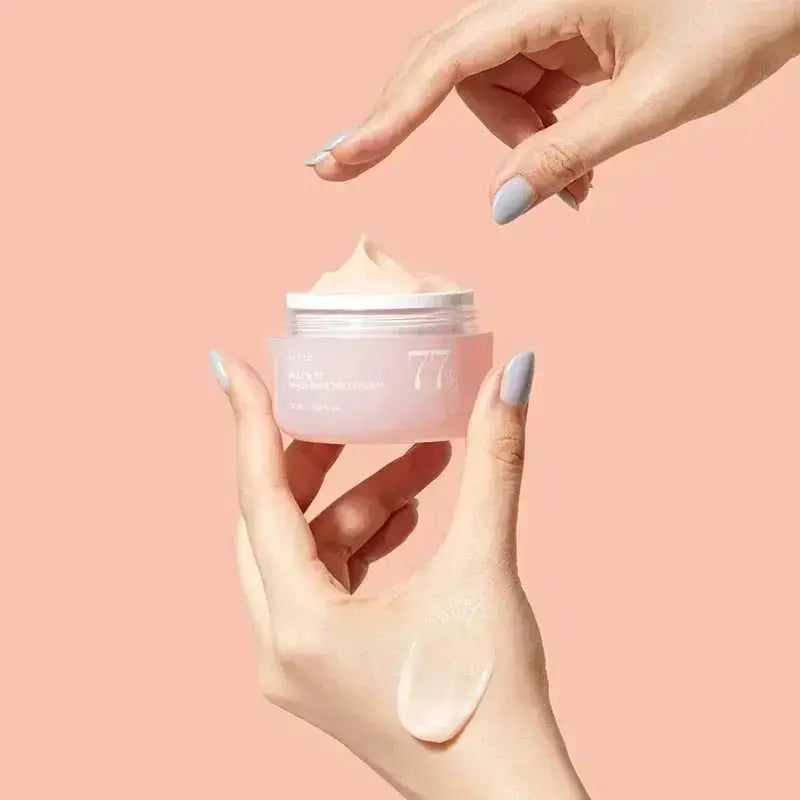 ANUA Peach 77% Niacin Enriched Cream in a 50 ml jar, showcasing the creamy texture and peach-inspired packaging.