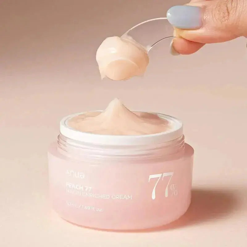 ANUA Peach 77% Niacin Enriched Cream 50 ml jar showing smooth peach-colored cream in a white container with a clear lid.