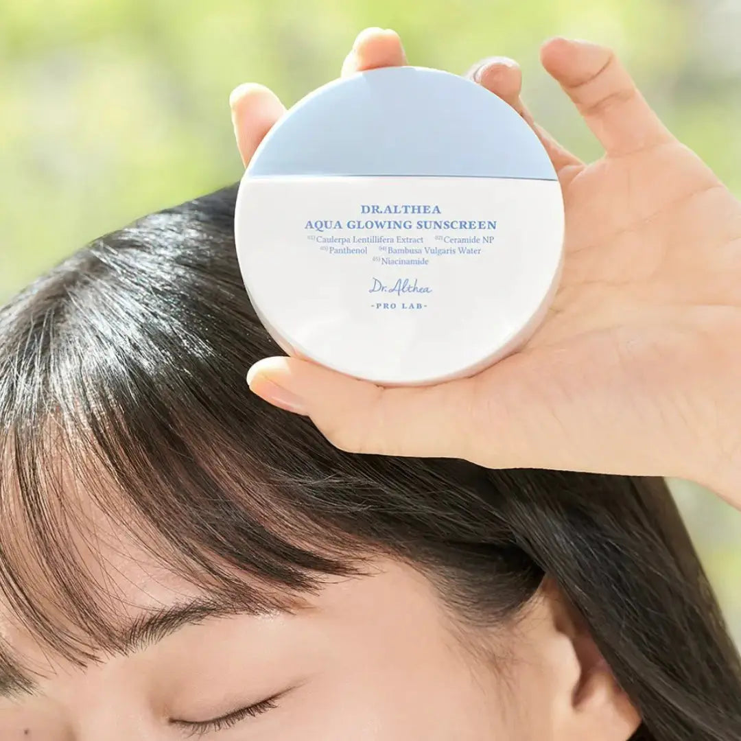 DR ALTHEA Aqua Glowing Sunscreen 45 ml bottle with blue and white packaging, featuring SPF protection and hydrating formula.