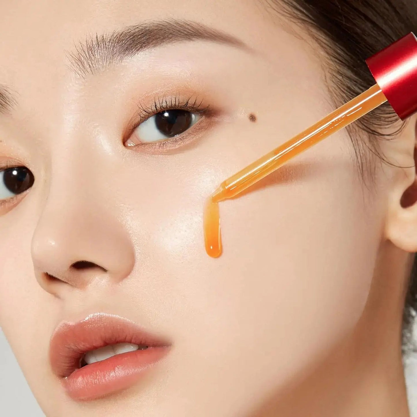 Medicube Red Acne Succinic Acid Peel Serum in a clear bottle with dropper, designed for acne-prone skin treatment.