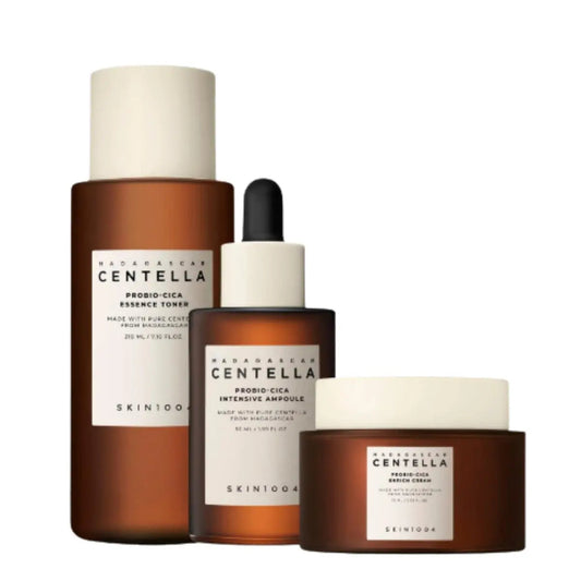 Skin1004 Madagascar Centella Probio-Cica toner, ampoule, and cream set with skincare products in jars and bottles.