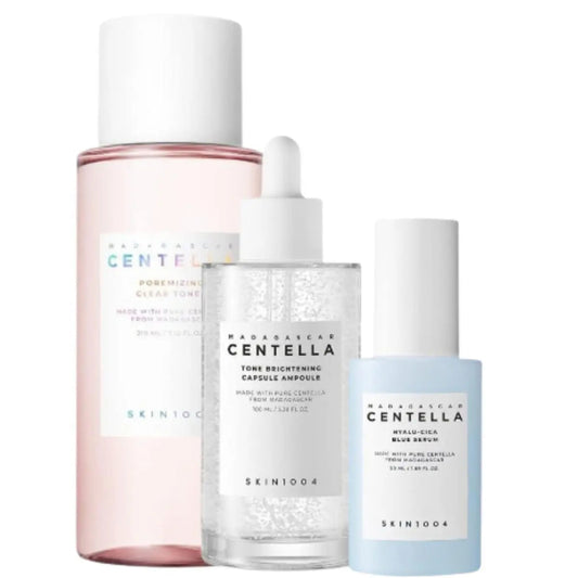Skin1004 toner, ampoule, and serum set displayed in bottles and containers, showcasing a skincare routine kit with natural packaging.
